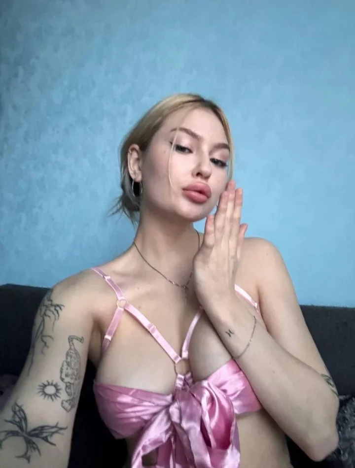 Blonde brat in pink ribbon ready to be unwrapped