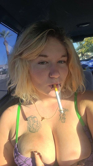 Smoking sexy in my car with my tits out